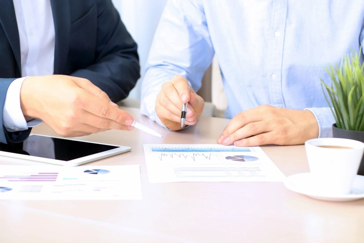 Business professionals reviewing charts at a table