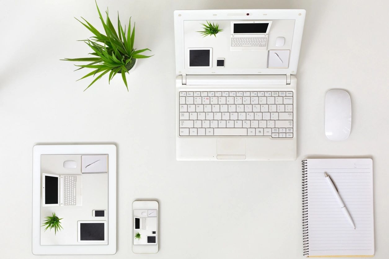 Organized office workspace with laptop and notebook